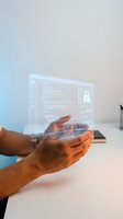 Dark-skinned male hands holding a glowing holographic screen with code and security lock icon, representing futuristic cybersecurity technology.