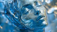 Female face with silver glitter makeup and blue liquid effect, eyes closed in serene expression against dark background, artistic beauty portrait for cosmetic advertising.