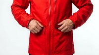 Man wearing bright red waterproof jacket with hands on zipper, isolated on white background. Suitable for outerwear, sportswear, and fashion retail marketing.