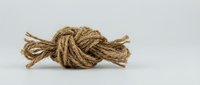 Twisted jute rope knot isolated on white background, ready for design projects, packaging, and craft applications.
