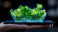 Futuristic holographic green lettuce leaf projection emerging from smartphone screen with glowing particles and digital effects. Modern food technology concept.