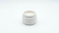 White cosmetic cream jar with open lid showing moisturizer inside, isolated on white background for skincare and beauty product design applications.