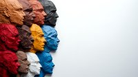 Colorful paper cut profiles arranged in rows showing diverse faces in side view against white background, representing unity and diversity in modern design.