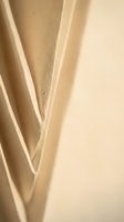 Abstract beige paper texture with curved folded layers creating geometric shadows and depth for modern design backgrounds.