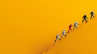 Silhouettes of diverse people running upward on vibrant yellow textured surface, symbolizing progress, teamwork, and achievement in business or personal growth.
