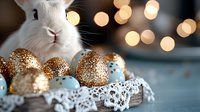White bunny peeking at decorated Easter eggs with gold glitter and blue patterns on vintage lace doily, soft bokeh lights creating festive holiday atmosphere.