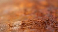 Rusty metal surface with oxidized texture and weathered patina, suitable for industrial backgrounds, grunge overlays, and design projects.