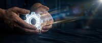 Hands of a middle-aged male professional holding glowing gear symbol with digital light trails, representing technology, innovation, and engineering solutions for business concepts.