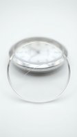 Clear glass petri dish with lid on white background for laboratory research and scientific experiments in medical testing facilities.