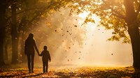 Mother and child walking hand in hand through golden autumn park with falling leaves and warm sunlight filtering through trees creating magical atmosphere.