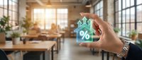 Businessman hand holding glowing house icon with percentage symbol representing mortgage rates and real estate investment in modern office space.