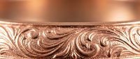 Elegant rose gold wedding band with intricate hand-engraved scrollwork and flourishes, luxury jewelry piece for bridal and engagement ceremonies.