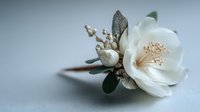Elegant white flower boutonniere with delicate buds and green leaves on neutral background for wedding ceremonies and formal events.