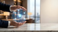 Professional businessman hands protecting digital security shield with network connections in modern office environment for cybersecurity and data protection concepts.