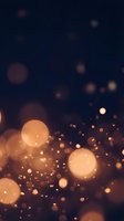 Abstract golden bokeh lights on dark background creating warm atmospheric glow for luxury design projects and festive celebrations.