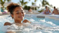 Young mixed race woman relaxing in outdoor jacuzzi spa with bubbling water, enjoying wellness retreat at tropical resort, eyes closed with serene smile.