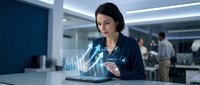 Professional businesswoman analyzing holographic data visualization on tablet in modern corporate office environment for technology presentations.