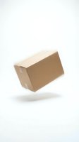 Tilted cardboard shipping box isolated on white background, ready for packaging, delivery, and logistics design projects.