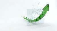 Green arrow breaking through glass wall symbolizing breakthrough, success, and overcoming obstacles in business growth and achievement.