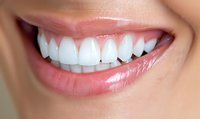 Close up view of healthy white teeth and pink lips showing genuine smile with natural dental care results for dentistry and oral hygiene concept.