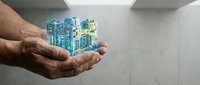 Elderly hands holding futuristic holographic city model with glowing skyscrapers in modern interior space for urban planning and smart city development.