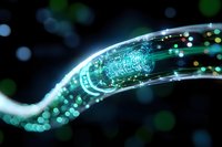 Glowing digital wave with circuit pattern and light particles flowing on dark background, representing data transmission and technological connectivity.