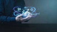 Businessman hands holding holographic quality assurance icons with gears and checkmarks representing digital QA processes and standards control.