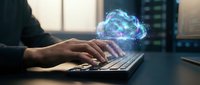 Hands typing on laptop with glowing digital brain hologram representing artificial intelligence, machine learning and neural network technology concepts.