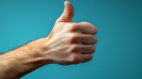 Male hand showing thumbs up gesture against turquoise background, expressing positivity, agreement and success. Professional studio lighting creates dramatic shadows.