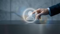 Businessman hand touching glowing user profile icon on digital interface, representing customer selection, recruitment, networking, and digital engagement for business applications.