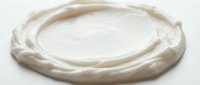 Creamy white cosmetic product swirl isolated on white background, ready for skincare packaging design and beauty product mockups.