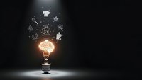 Glowing light bulb with culinary icons floating above on dark background representing cooking creativity and kitchen innovation concepts.