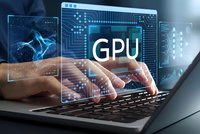 Professional working on laptop with GPU processing technology interface displaying circuit patterns and digital graphics overlay for computing applications.