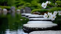 Tranquil stepping stones across calm water with delicate white cherry blossoms in foreground, creating zen garden atmosphere for wellness and meditation concepts.