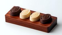 Luxury chocolate candies with leaf design on wooden serving board, dark and white chocolate pralines arranged symmetrically, gourmet confectionery display.
