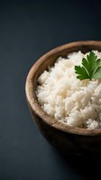 Cooked white rice in wooden bowl garnished with fresh parsley on dark background for culinary and food photography projects.