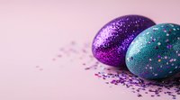 Glittery Easter eggs in vibrant purple and turquoise colors with scattered sparkles on pink background, festive holiday decoration for spring celebration.