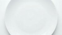 Empty white round plate isolated on white background, suitable for food photography, product mockups, dinnerware design, and culinary presentations.