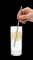 Hand holding stainless steel drinking straw in glass of water with lemon slice, isolated on transparent background, ready for design use on t-shirts, clipart, and print-on-demand products.