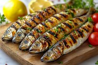 Grilled whole fish with herbs on wooden board, fresh lemon and cherry tomatoes. Healthy Mediterranean seafood dinner preparation for restaurant menu.