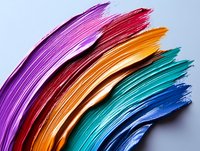 Vibrant rainbow-colored paper sheets arranged in curved layers creating dynamic abstract composition with rich texture and gradient color transition on light background.