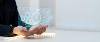 Businessman holding transparent digital interface with glowing gears, clock and data analytics icons for technology, innovation and business solutions.