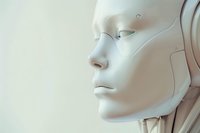 White robotic face in profile view showing detailed artificial features against light background, representing advanced technology and artificial intelligence.