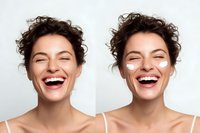 Young woman with curly brown hair laughing joyfully showing genuine happiness and positive emotions against white background for lifestyle content.