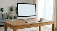 Modern wooden desk with computer monitor, keyboard and coffee cup in bright home office workspace with plants and sofa.