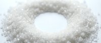 Granulated white sugar arranged in circular ring shape on white background, isolated for food packaging and culinary design use.