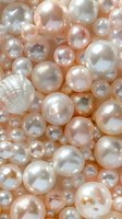 Lustrous pink and white pearls with seashell in macro view, showcasing varying sizes and iridescent surfaces for luxury jewelry design.