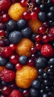 Fresh mixed berries with water drops - blueberries, red currants, and cloudberries creating vibrant natural pattern for healthy eating and food design.