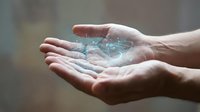 Young adult male hands holding glowing digital globe with network connections, representing global technology, data transfer, and worldwide business communication concepts.