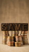 Wooden letter blocks spelling SAVE balanced on stacks of coins representing savings, financial planning, and money management concepts for business use.